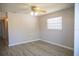 Cozy bedroom with neutral paint, modern ceiling fan, and sleek laminate flooring, creating a serene retreat at 4402 Ohio Ave, Tampa, FL 33616