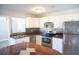 Modern kitchen featuring stainless steel appliances, ample counter space, and white cabinetry for a bright, clean look at 4402 Ohio Ave, Tampa, FL 33616