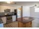 Open kitchen showcasing stainless steel appliances, wooden island, and sleek countertops, perfect for cooking and entertaining at 4402 Ohio Ave, Tampa, FL 33616