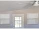 Bright living room features updated ceiling fan, a vaulted ceiling, natural light, and neutral paint at 4402 Ohio Ave, Tampa, FL 33616