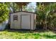 Backyard shed for storage with ample green surrounding it at 4402 Ohio Ave, Tampa, FL 33616