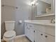 Bathroom with white toilet, white vanity with drawers, and neutral-colored walls at 4760 Silver Cir, Zephyrhills, FL 33541