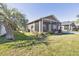 This beautifully landscaped yard showcases a charming screened porch, and well-maintained green space at 4760 Silver Cir, Zephyrhills, FL 33541