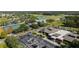 Community clubhouse featuring tennis courts, pool, parking, and a green park-like space, promising an active lifestyle at 4915 Churchill Pl, Land O Lakes, FL 34639