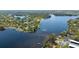 Scenic aerial view of a deep blue lake surrounded by homes and lush greenery at 4915 Churchill Pl, Land O Lakes, FL 34639