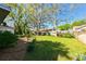 Beautiful backyard with mature trees offering shade and a well-maintained lawn at 4915 Churchill Pl, Land O Lakes, FL 34639