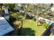 Aerial view of a backyard boasting a lush lawn, privacy fence, and mature trees at 4915 Churchill Pl, Land O Lakes, FL 34639