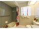 Bathroom boasts tiled floors, a floral shower curtain, and modern fixtures at 4915 Churchill Pl, Land O Lakes, FL 34639