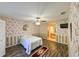 Inviting bedroom with floral wallpaper, wood floors, and an ensuite bathroom at 4915 Churchill Pl, Land O Lakes, FL 34639