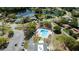 An aerial view of the community pool surrounded by lush landscaping and neighborhood at 4915 Churchill Pl, Land O Lakes, FL 34639