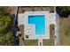 Aerial view of the rectangular community pool, surrounded by lounge chairs and tables at 4915 Churchill Pl, Land O Lakes, FL 34639