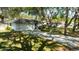 Charming home featuring a lush front yard with mature trees and an extended driveway at 4915 Churchill Pl, Land O Lakes, FL 34639