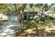 Beautifully landscaped front yard of a well-maintained home featuring mature trees for shade at 4915 Churchill Pl, Land O Lakes, FL 34639