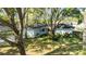 A well-manicured front yard with mature trees and landscaping enhance this charming home at 4915 Churchill Pl, Land O Lakes, FL 34639
