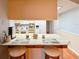 Kitchen counter with seating area offering a view of the kitchen's appliances at 4915 Churchill Pl, Land O Lakes, FL 34639