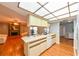 Open kitchen with a breakfast bar, pantry, and a view into the living room with a fireplace at 4915 Churchill Pl, Land O Lakes, FL 34639