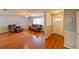 Inviting living room with hardwood floors, neutral wall colors, a ceiling fan, and comfortable leather furniture at 4915 Churchill Pl, Land O Lakes, FL 34639