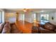 Open-concept living area featuring hardwood floors, neutral tones, ceiling fan, and easy access to other rooms at 4915 Churchill Pl, Land O Lakes, FL 34639