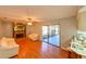 Living room features wood-look flooring and a fireplace, with a view of the kitchen at 4915 Churchill Pl, Land O Lakes, FL 34639