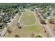 Aerial view of a running track surrounded by athletic facilities and residential areas at 4915 Churchill Pl, Land O Lakes, FL 34639