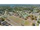 Aerial view of tennis courts and a running track in a well-treed community at 4915 Churchill Pl, Land O Lakes, FL 34639