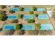 Aerial view of the community tennis courts surrounded by mature trees and landscaping at 4915 Churchill Pl, Land O Lakes, FL 34639