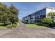 Exterior view of the building showcasing balconies and landscaping with easy access to parking at 50 Harbor View Ln # 21, Belleair Bluffs, FL 33770