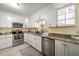 Modern kitchen with stainless steel appliances, granite countertops, and ample cabinet space at 50 Harbor View Ln # 21, Belleair Bluffs, FL 33770