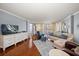 Bright living room with wood floors, comfortable seating, and floor-to-ceiling windows overlooking the city at 50 Harbor View Ln # 21, Belleair Bluffs, FL 33770