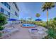 Relaxing pool area featuring lounge chairs and umbrellas, great for enjoying sunny days at 50 Harbor View Ln # 21, Belleair Bluffs, FL 33770