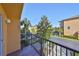 Open-air balcony with views of manicured landscaping, trees, and neighborhood townhomes in the distance at 5036 Sand Castle Dr, New Port Richey, FL 34652