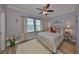 Bedroom with plush bedding, a ceiling fan, and natural light from two windows at 5036 Sand Castle Dr, New Port Richey, FL 34652