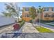 Charming townhouse with tan exterior, balcony, driveway, one car garage, and lush landscaping at 5036 Sand Castle Dr, New Port Richey, FL 34652