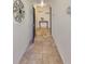 Tiled hallway featuring decorative elements and neutral wall colors at 5036 Sand Castle Dr, New Port Richey, FL 34652