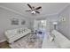 Cozy living room with stylish furniture, large windows, and a ceiling fan for added comfort at 5036 Sand Castle Dr, New Port Richey, FL 34652