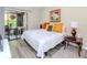 Comfortable bedroom featuring a slider to the screened porch, table lamps, and modern flooring at 5100 Burchette Rd # 500, Tampa, FL 33647