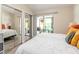 Comfortable bedroom featuring a slider to the screened porch, mirrored closet doors, and modern flooring at 5100 Burchette Rd # 500, Tampa, FL 33647