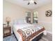 Cozy bedroom featuring two windows, a ceiling fan, and a colorful floral quilt on the bed at 5100 Burchette Rd # 500, Tampa, FL 33647
