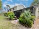 Back exterior with lanai, beautiful landscaping, and a paver stone walkway at 5100 Burchette Rd # 500, Tampa, FL 33647