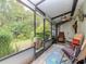 Screened-in lanai featuring neutral furniture, ceiling fan, and backyard views at 5100 Burchette Rd # 500, Tampa, FL 33647