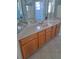 Bright bathroom boasts tile flooring, wood cabinets, and a large countertop at 5261 Camberlea Ave, Zephyrhills, FL 33541