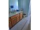 Bathroom featuring wood cabinets, sink, mirror and neutral colored walls at 5261 Camberlea Ave, Zephyrhills, FL 33541
