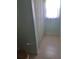 Neutral bathroom with large tile flooring and a white shower curtain at 5261 Camberlea Ave, Zephyrhills, FL 33541