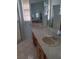 Bathroom vanity featuring a sink, countertop, storage cabinets, and large mirror at 5261 Camberlea Ave, Zephyrhills, FL 33541