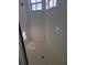 Bathroom with tile shower with white tile and glass door with window at 5261 Camberlea Ave, Zephyrhills, FL 33541