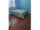 Cozy bedroom with neutral decor, wood floors, and a large window at 5261 Camberlea Ave, Zephyrhills, FL 33541