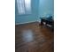 Bright bedroom with a large window and dark wooden floors at 5261 Camberlea Ave, Zephyrhills, FL 33541