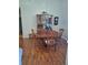 Dining room featuring hardwood floors, a classic china cabinet, and a round wooden table at 5261 Camberlea Ave, Zephyrhills, FL 33541
