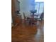 Dining room with wooden table and chairs, wooden floors, and blue flowers at 5261 Camberlea Ave, Zephyrhills, FL 33541