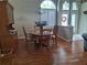 Dining room featuring hardwood floors, a classic china cabinet, and a round wooden table at 5261 Camberlea Ave, Zephyrhills, FL 33541